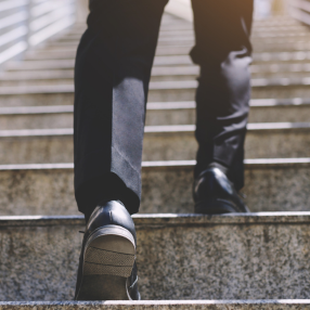 Man in suit going up the stairs