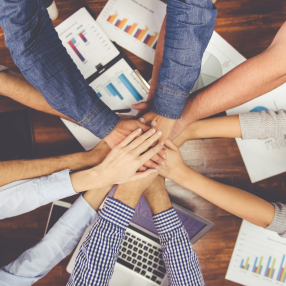 People putting hands on another